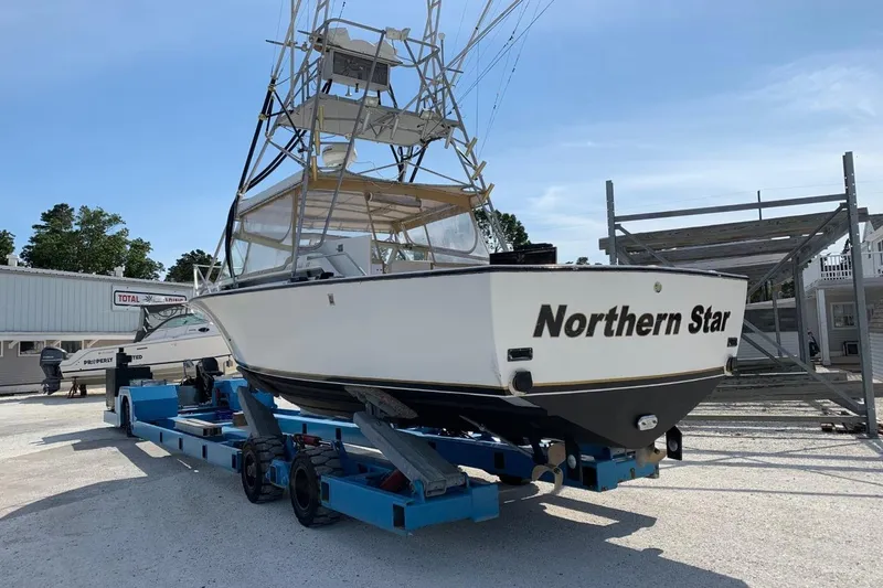 Slide: The Image of 1977 Bertram 28 Moppie boat "Northern Star" on trailer at marina. - 28