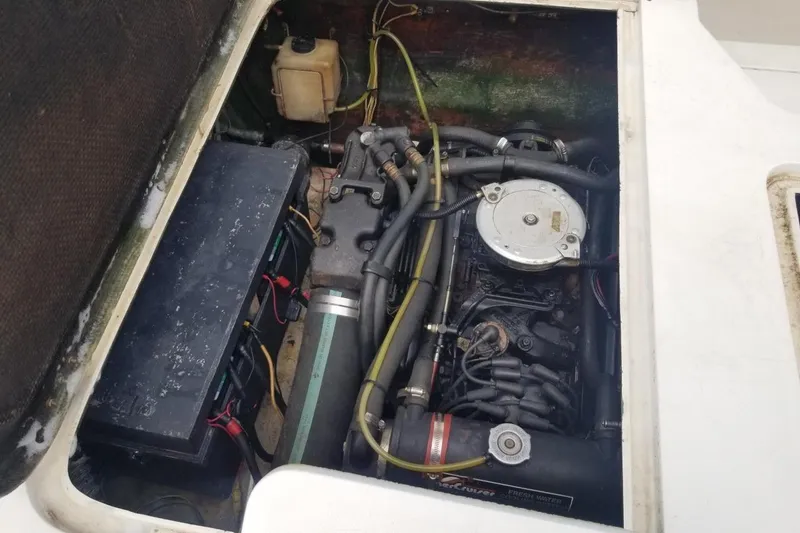 Slide: The Image of Engine compartment of a 1977 Bertram 28 Moppie boat, showcasing mechanical components. - 7