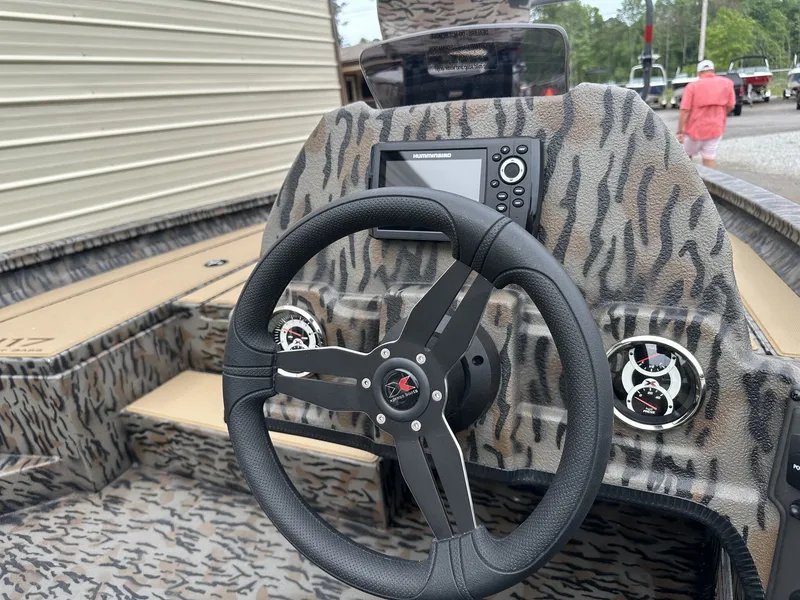 Slide: The Image of Interior of 2026 Xpress H17 boat with steering wheel and instruments. - 7