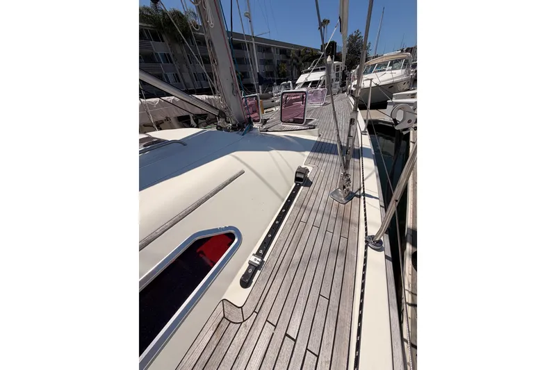 Slide: The Image of 2006 Hanse 461 sailboat deck with wooden finish, docked in a marina. - 16