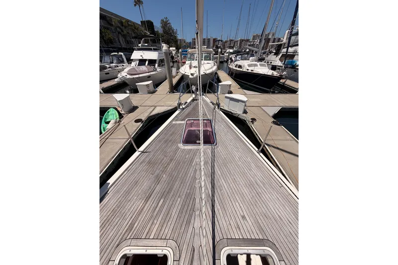 Slide: The Image of 2006 Hanse 461 yacht docked at marina, showcasing sleek deck design and surrounding boats. - 18