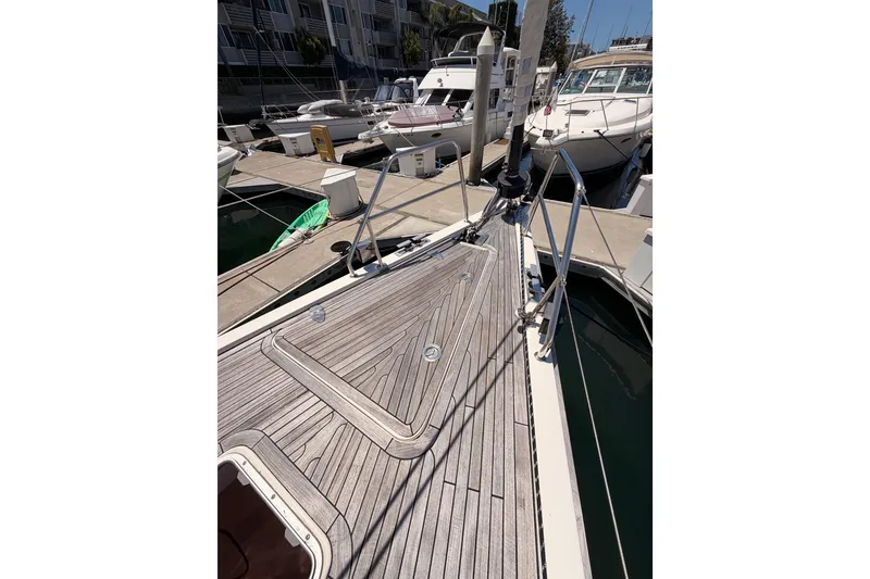 Slide: The Image of 2006 Hanse 461 yacht with wooden deck, docked at marina. - 19