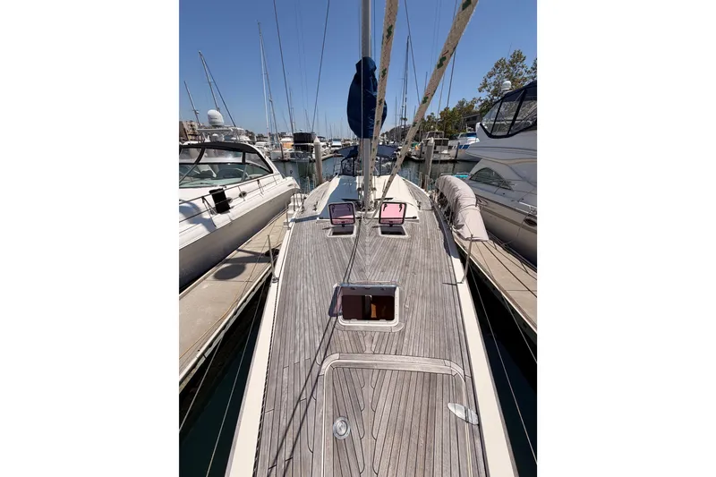 Slide: The Image of 2006 Hanse 461 sailboat docked at marina, showcasing sleek deck design and rigging. - 23