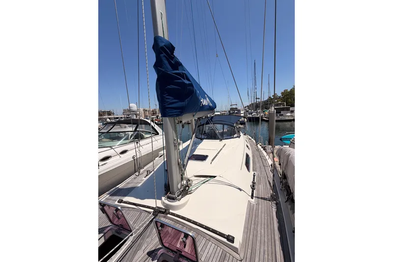 Slide: The Image of Sailboat Hanse 461, 2006 model, docked in a marina under clear blue skies. - 24