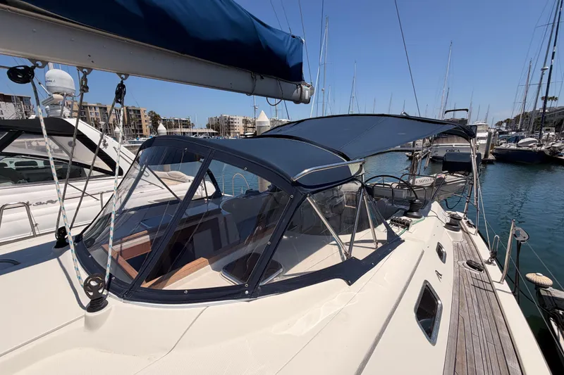 Slide: The Image of 2006 Hanse 461 yacht docked in marina, featuring sleek design and spacious deck. - 25