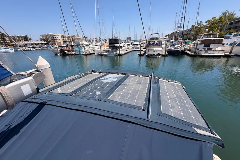 Slide: The Image of 2006 Hanse 461 yacht with solar panels docked in a marina. - 26
