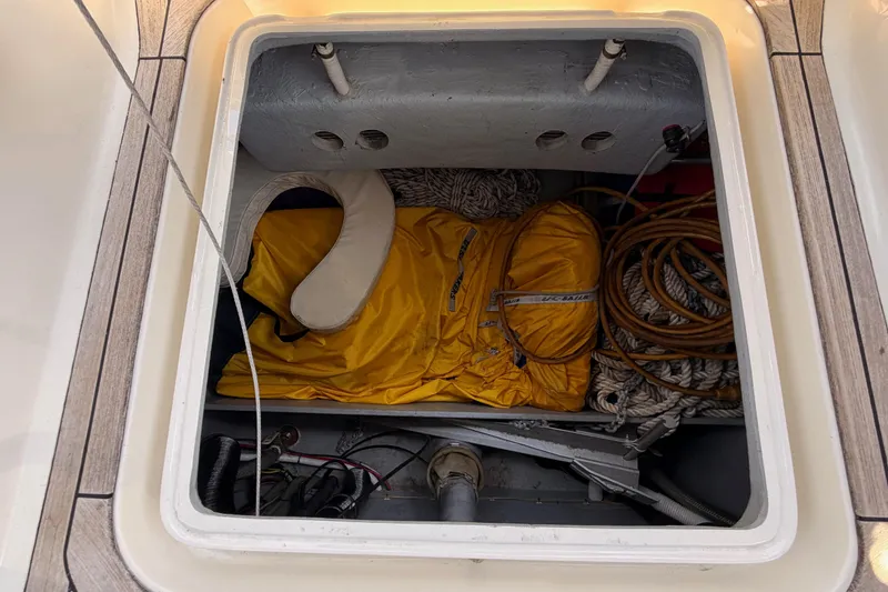 Slide: The Image of Storage compartment on a 2006 Hanse 461 yacht with ropes and a yellow life jacket. - 31
