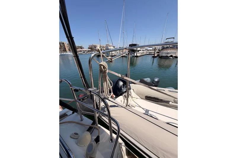 Slide: The Image of Sailboat Hanse 461 (2006) docked in a marina, surrounded by calm waters and other boats. - 33