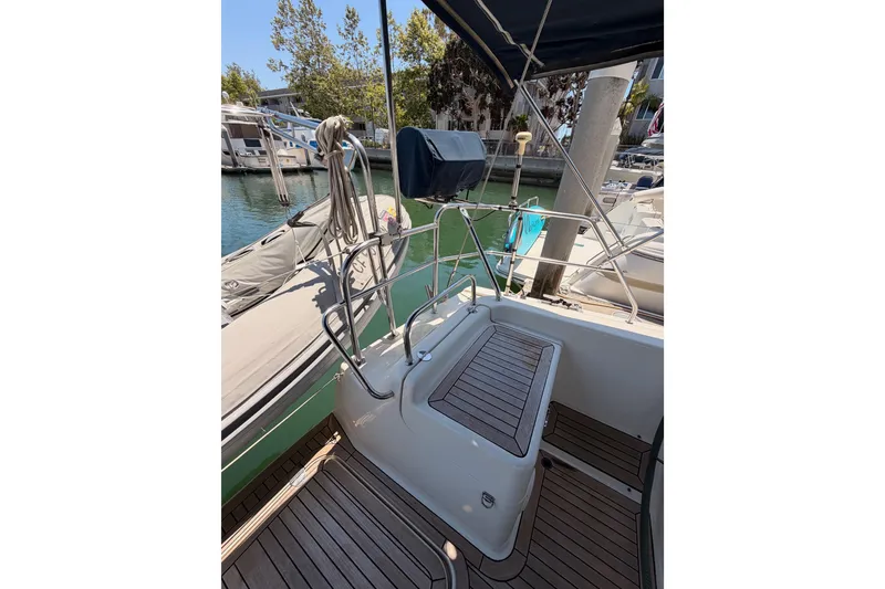 Slide: The Image of 2006 Hanse 461 sailboat cockpit with teak flooring, docked in a marina. - 34