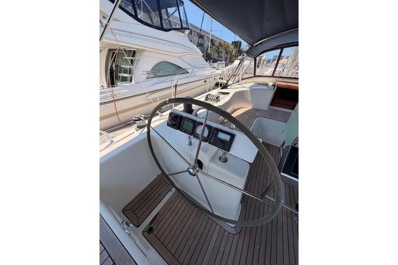 Slide: The Image of Steering wheel of 2006 Hanse 461 yacht with wooden deck and navigation instruments. - 35