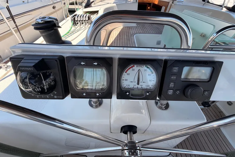 Slide: The Image of Cockpit instruments on a 2006 Hanse 461 yacht, featuring navigation and wind gauges. - 36