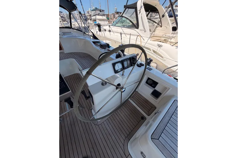 Slide: The Image of Steering wheel of a 2006 Hanse 461 yacht, docked in a marina. - 38
