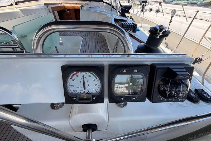 Slide: The Image of Cockpit of 2006 Hanse 461 sailboat featuring navigation instruments and steering wheel. - 39