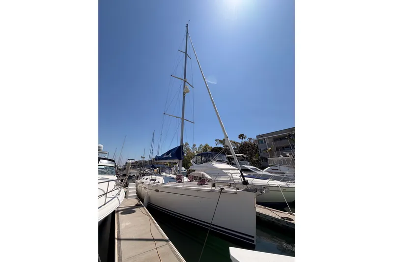 Slide: The Image of 2006 Hanse 461 sailboat docked under clear blue sky. - 4