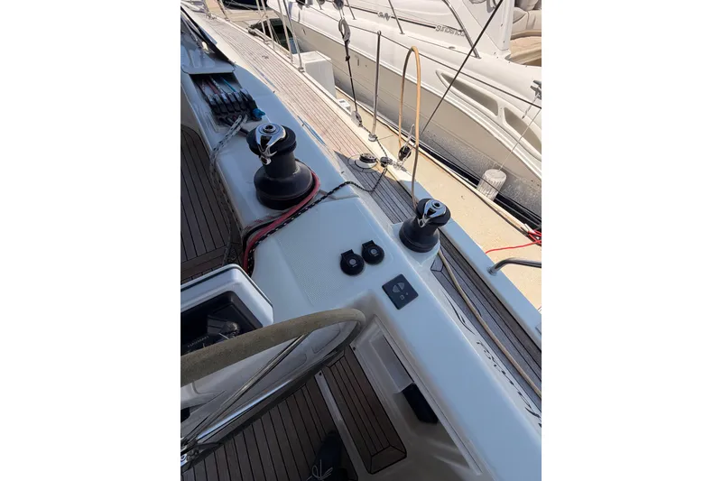Slide: The Image of Deck view of a 2006 Hanse 461 sailboat, featuring winches and teak flooring. - 40