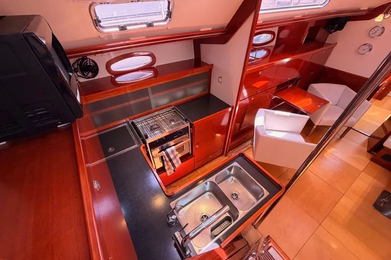 Slide: The Image of Luxurious interior of 2006 Hanse 461 yacht featuring modern kitchen and cozy seating area. - 45