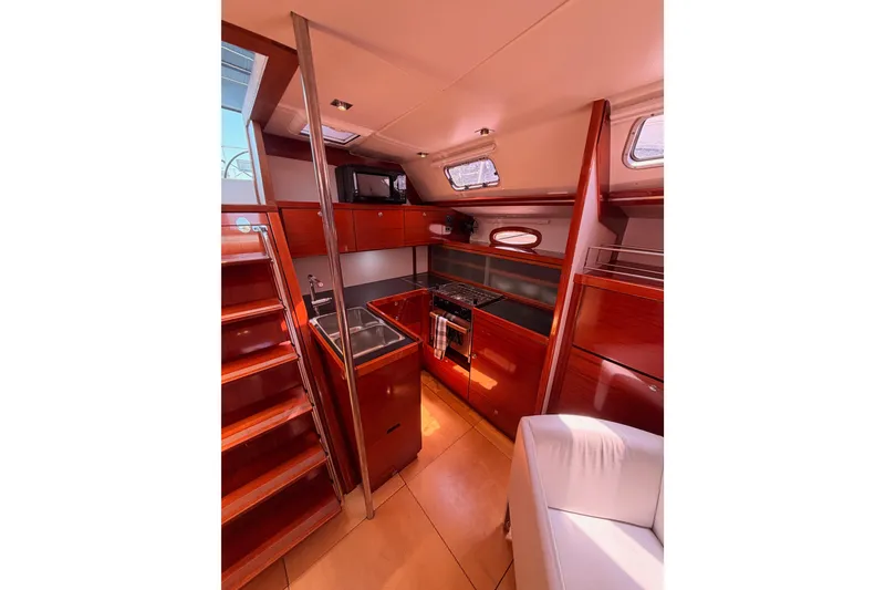 Slide: The Image of Interior of 2006 Hanse 461 yacht with wooden cabinetry and modern kitchen amenities. - 46