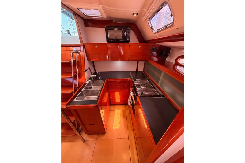 Slide: The Image of Interior of 2006 Hanse 461 yacht kitchen with wooden cabinetry and modern appliances. - 47