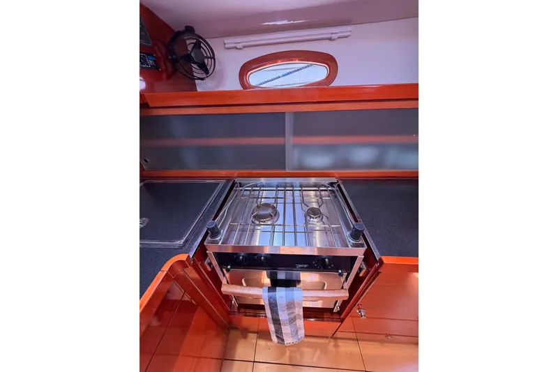 Slide: The Image of Compact kitchen area in a 2006 Hanse 461 yacht, featuring a stainless steel stove. - 50