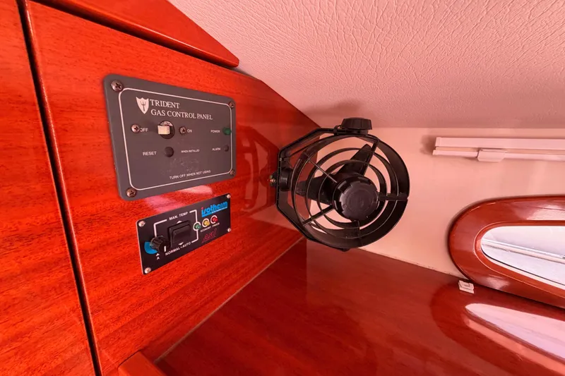 Slide: The Image of Control panel and fan inside 2006 Hanse 461 yacht cabin, featuring wood finish. - 52