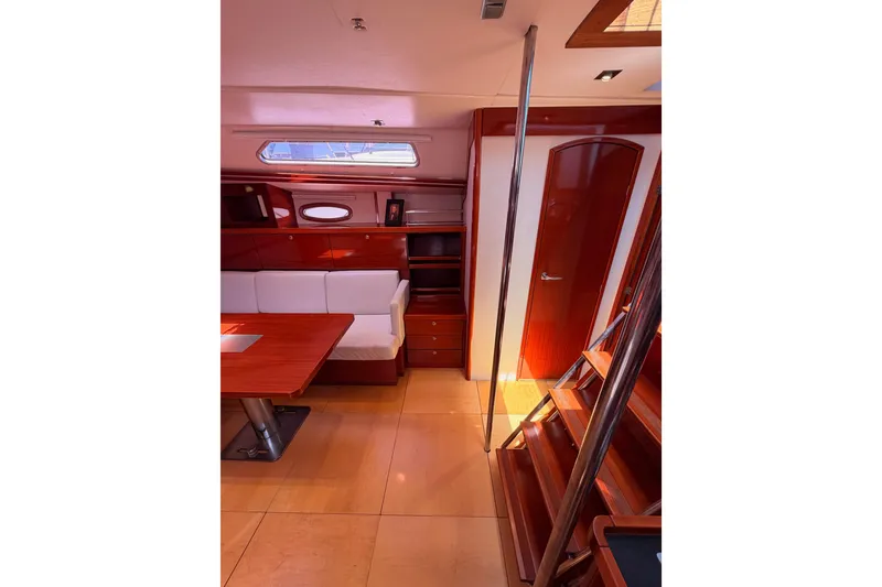 Slide: The Image of Interior of 2006 Hanse 461 yacht with wooden finishes and cozy seating area. - 55