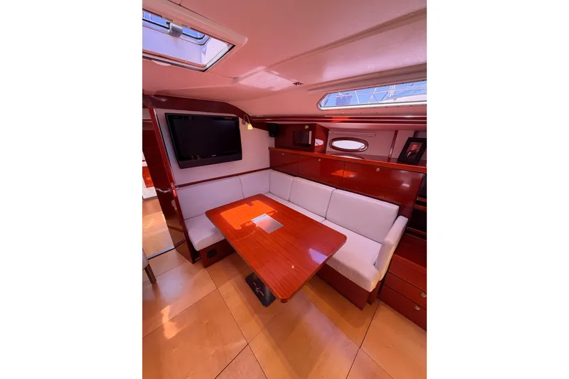 Slide: The Image of Luxurious interior of 2006 Hanse 461 yacht with elegant wood finish and cozy seating. - 56