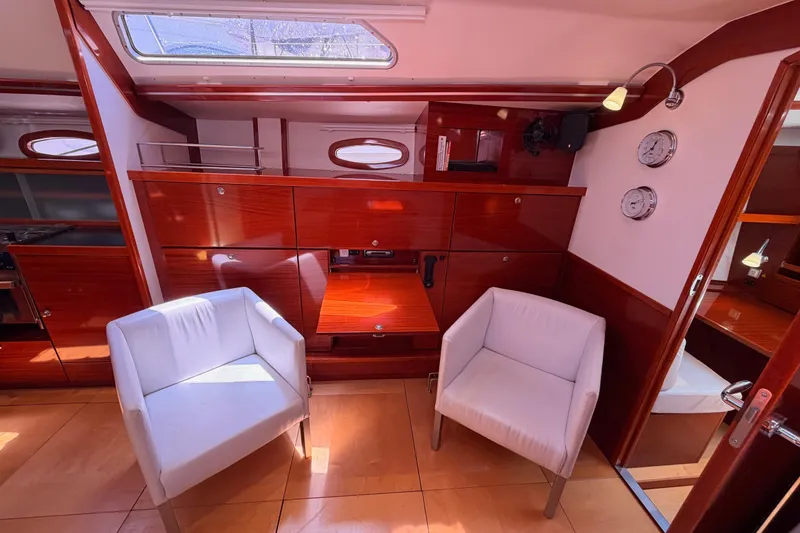 Slide: The Image of Luxurious 2006 Hanse 461 yacht interior with elegant wood finish and modern white chairs. - 59