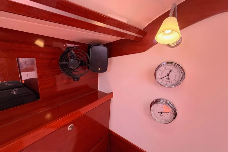 Slide: The Image of Interior of 2006 Hanse 461 yacht with fan, speaker, and nautical instruments. - 61