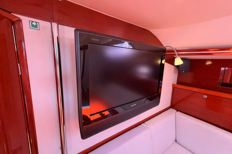 Slide: The Image of Flat-screen TV in 2006 Hanse 461 yacht interior with wooden paneling. - 62