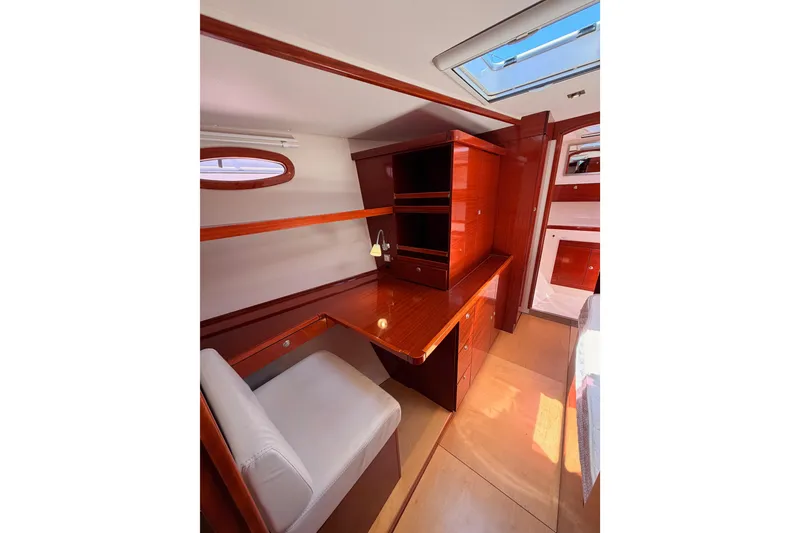Slide: The Image of Interior of 2006 Hanse 461 yacht with wooden desk and white chair. - 64