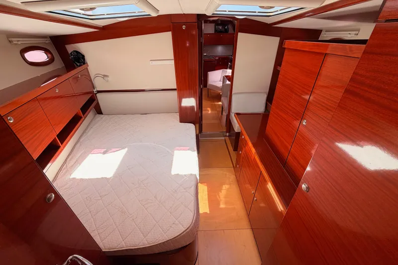 Slide: The Image of Luxurious 2006 Hanse 461 yacht cabin with polished wood finish and cozy bed. - 72