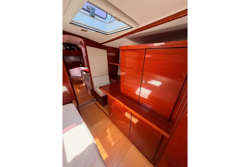 Slide: The Image of Luxurious interior of 2006 Hanse 461 yacht with polished wood cabinetry and skylight. - 73