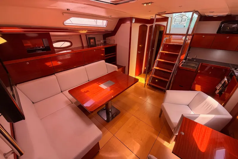 Slide: The Image of Luxurious interior of a 2006 Hanse 461 yacht with elegant wood finishes and modern seating. - 76