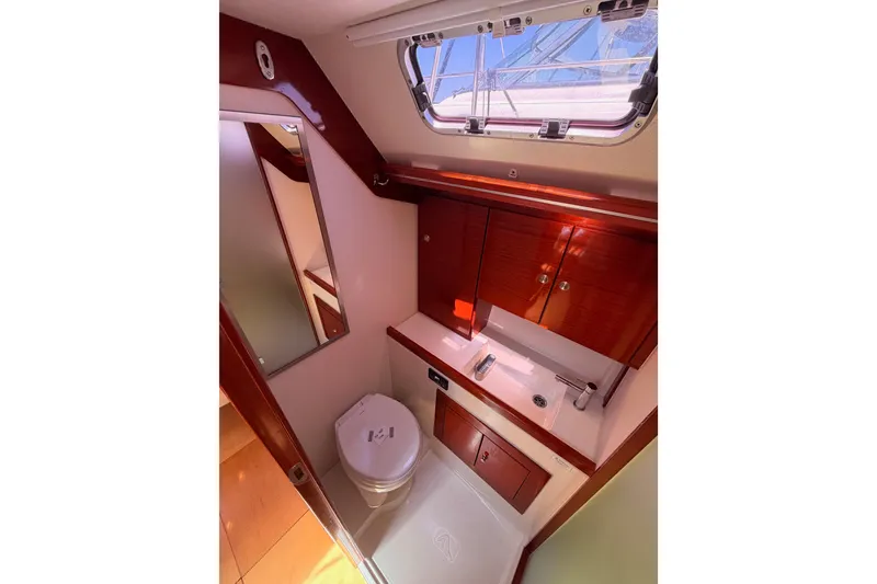 Slide: The Image of Luxurious 2006 Hanse 461 yacht bathroom with wooden cabinetry and modern fixtures. - 79