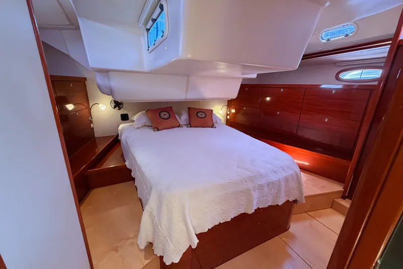 Slide: The Image of Luxurious cabin interior of 2006 Hanse 461 yacht with cozy bed and wooden furnishings. - 82