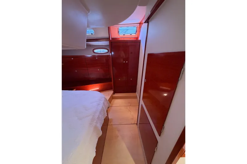 Slide: The Image of Interior of 2006 Hanse 461 yacht cabin with wood paneling and bed. - 84