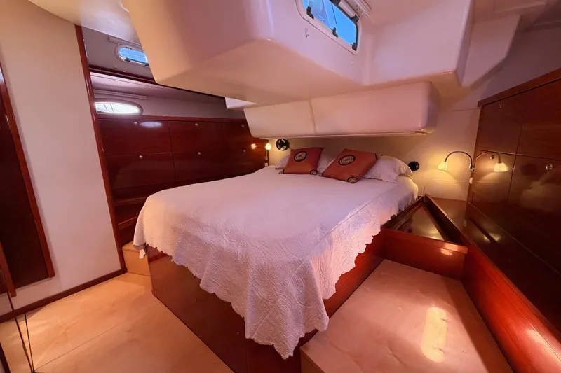 Slide: The Image of Luxurious cabin interior of 2006 Hanse 461 yacht with cozy bed and elegant wood finish. - 86