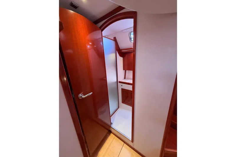 Slide: The Image of Interior of 2006 Hanse 461 yacht showing wooden door and compact bathroom. - 87