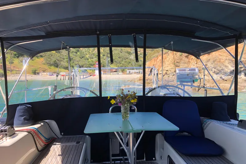 Slide: The Image of Interior view of 2006 Hanse 461 yacht with table and scenic coastal backdrop. - 95