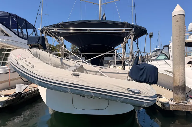 Slide: The Image of 2006 Hanse 461 yacht docked with inflatable boat, sunny marina setting. - 96