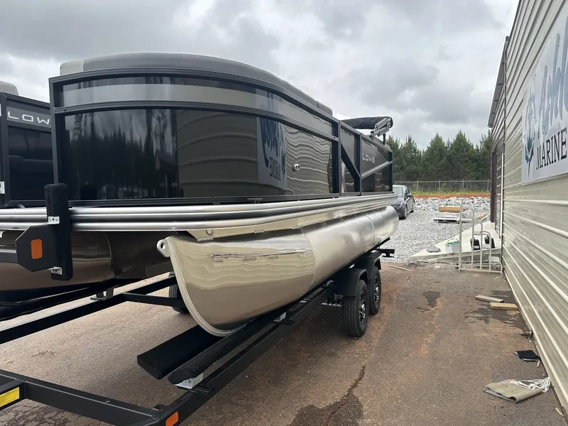 Slide: The Image of Lowe LS Walk Thru 190 pontoon boat, 2026 model, parked on trailer. - 3