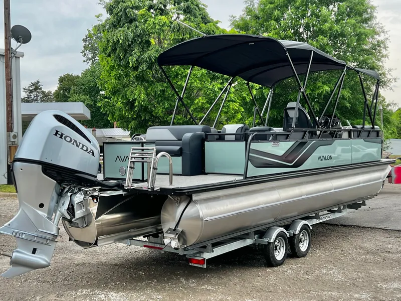 Slide: The Image of 2026 Avalon Venture 85 pontoon boat with Honda engine on trailer. - 5