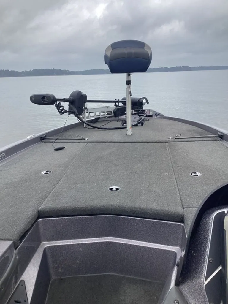 Slide: The Image of 2017 Skeeter ZX250 boat on calm water under cloudy sky. - 11