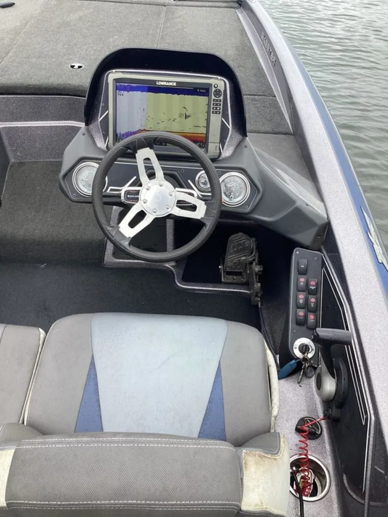 Slide: The Image of Interior view of a 2017 Skeeter ZX250 boat with steering console. - 17