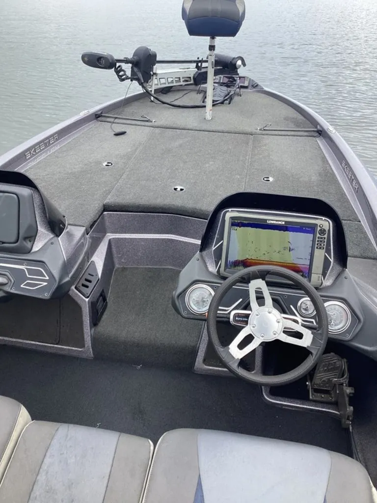 Slide: The Image of Interior view of a 2017 Skeeter ZX250 boat with steering console. - 18