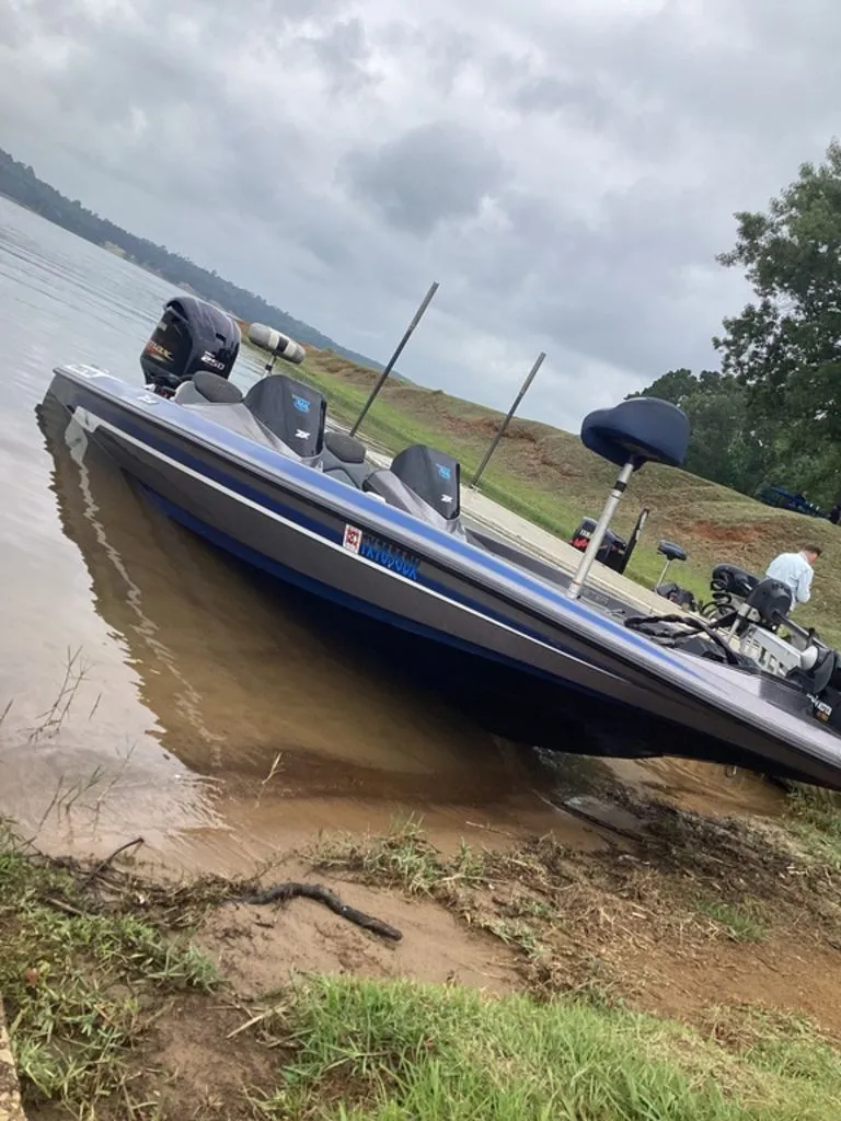 Slide: The Image of 2017 Skeeter ZX250 boat at lakeside under cloudy sky. - 29