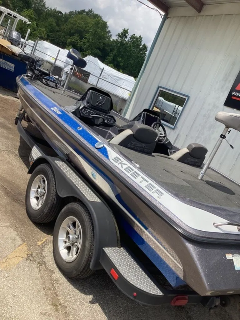 Slide: The Image of 2017 Skeeter ZX250 boat on trailer outside building. - 38