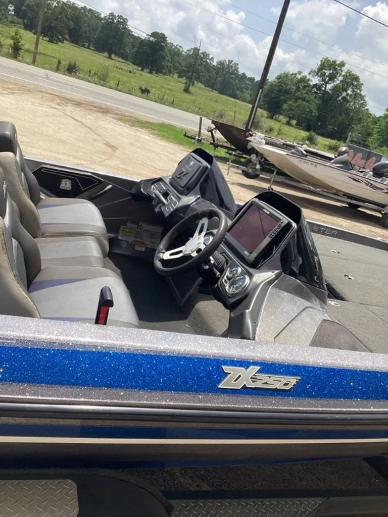 Slide: The Image of Interior of a 2017 Skeeter ZX250 boat with steering console. - 42
