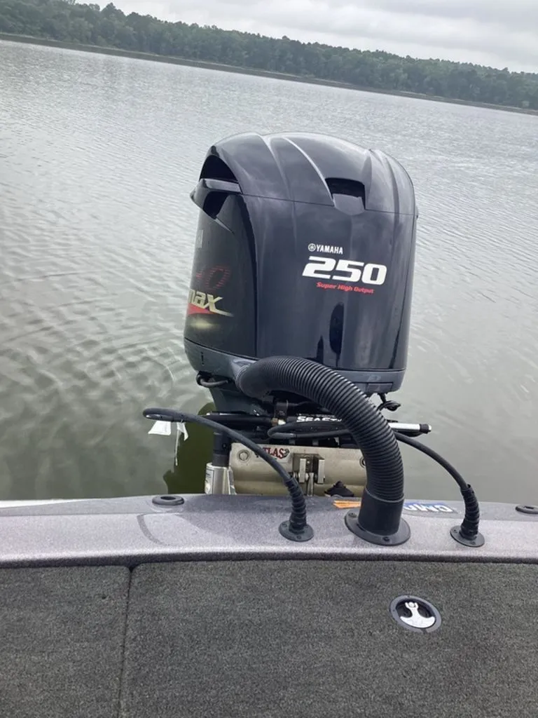 Slide: The Image of Yamaha 250 outboard motor on Skeeter ZX250 boat, calm lake. - 6