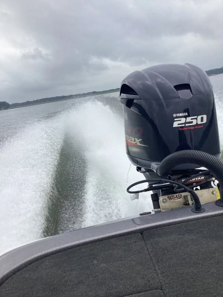 Slide: The Image of Skeeter ZX250 boat with Yamaha 250 HP engine on water. - 9